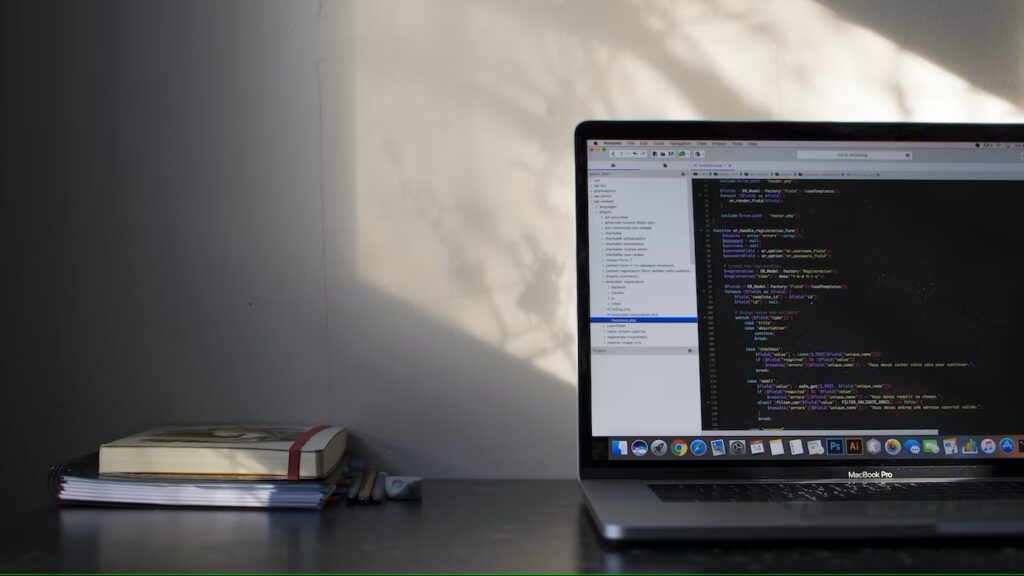 A laptop on the table showing coding work