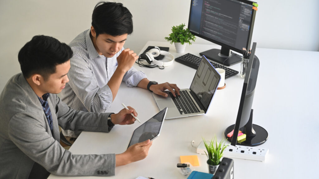 Two employees are wroking on website development project for client