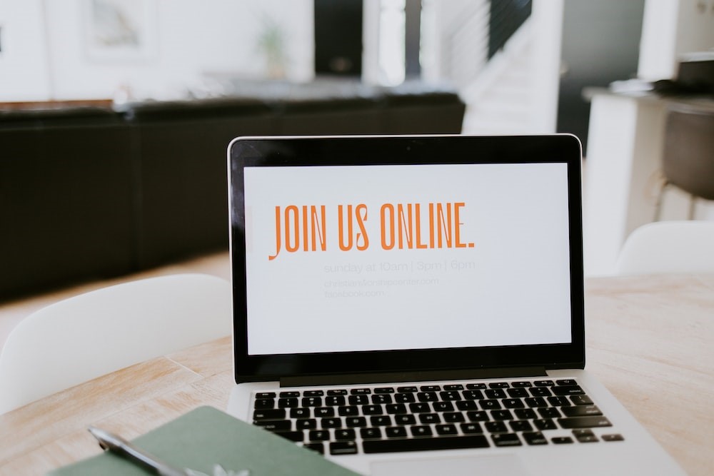 A laptop is showing "Join us online"